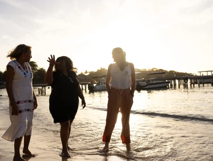 Conservationists walking the beach in Roatan, Honduras