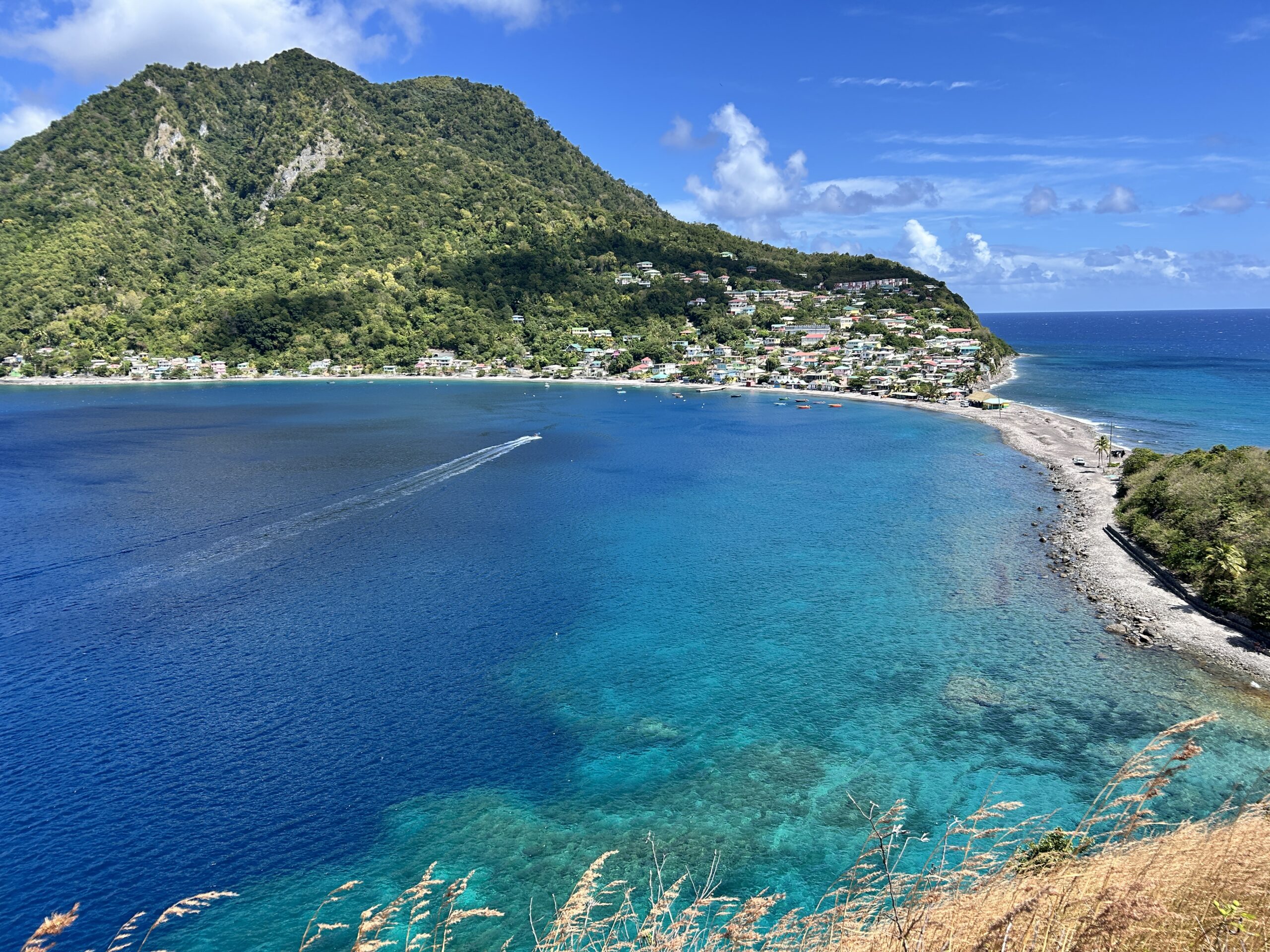 Crystal clear ocean water and sunny, blue skies at Scotts Head Marine Reserve in Dominica
