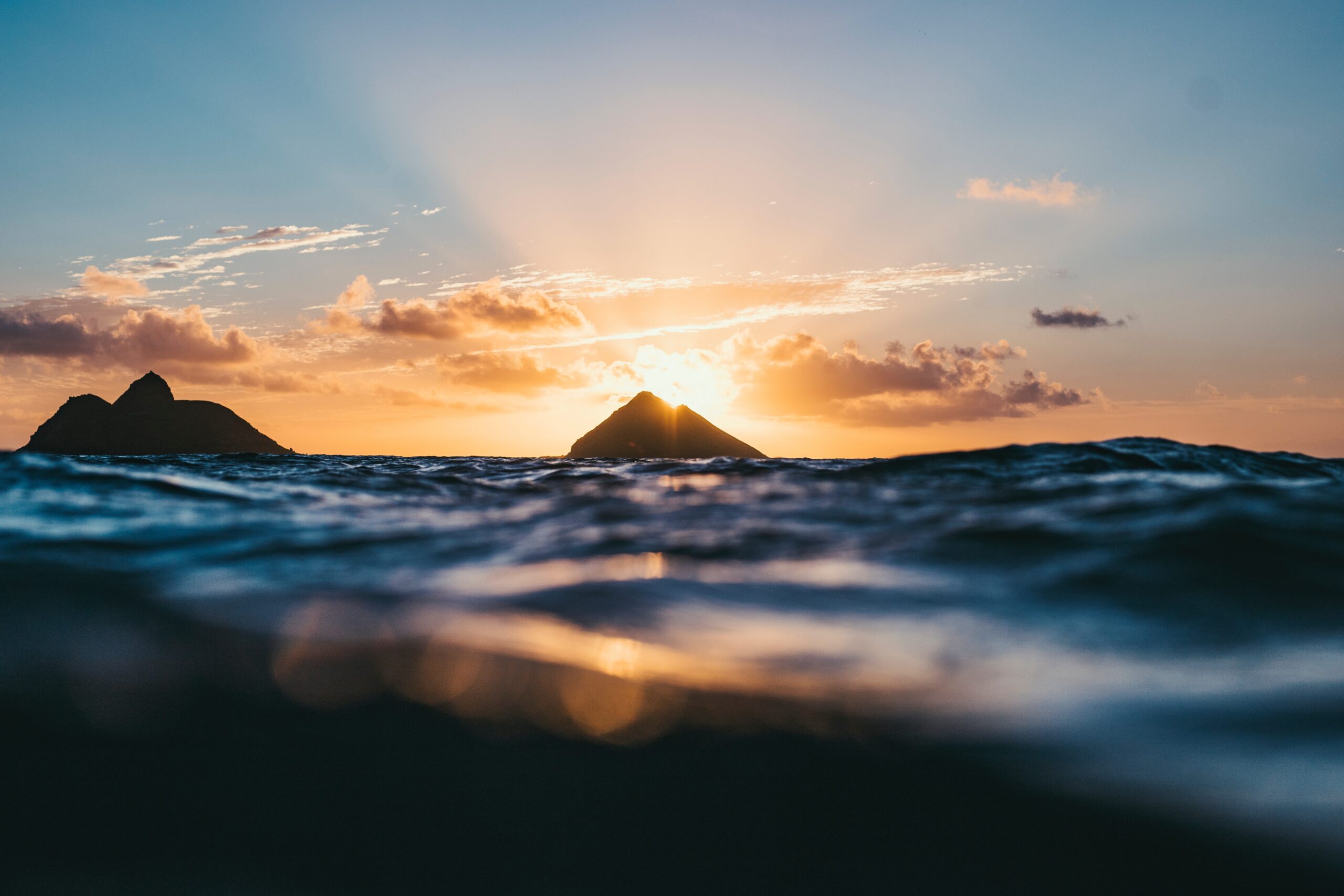 Water view of two islands at sunset