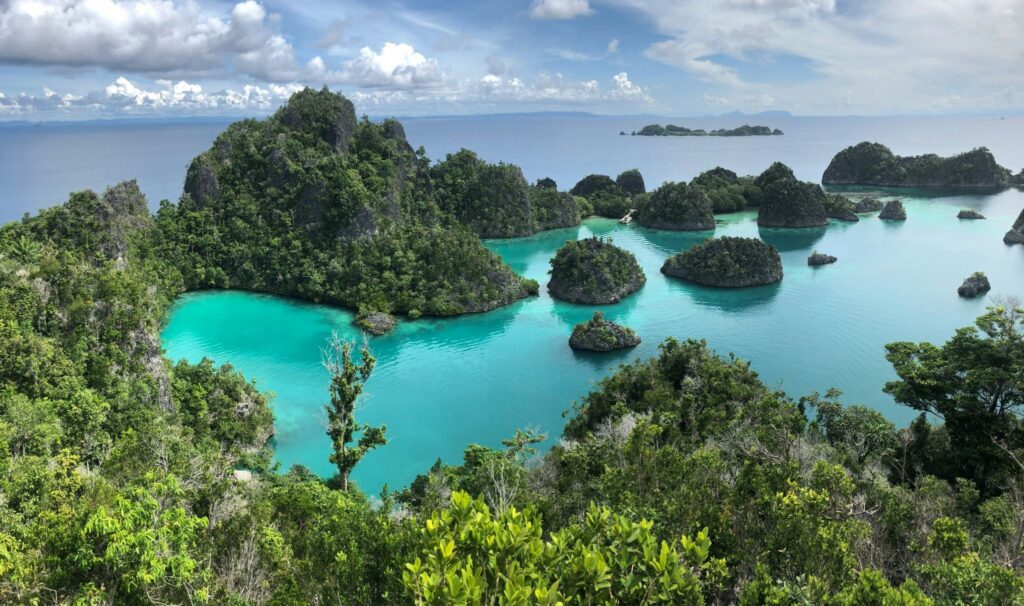 A mountainous cluster of tiny islands with turquoise waters and lush green forests